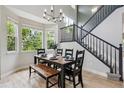 Formal dining room with large windows and contemporary chandelier at 2934 Braeburn Way, Highlands Ranch, CO 80126