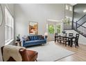 Bright living room features a soaring ceiling and modern decor at 2934 Braeburn Way, Highlands Ranch, CO 80126