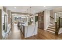 Modern kitchen featuring a waterfall island, stainless steel appliances, and a convenient sliding barn door at 5880 Beeler Ct, Denver, CO 80238