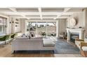 Cozy living room featuring a fireplace, hardwood floors, and sliding glass doors to an outdoor deck at 5880 Beeler Ct, Denver, CO 80238