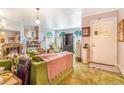 Cozy living room with fireplace, arched windows, and retro green furniture at 2421 N York St, Denver, CO 80205