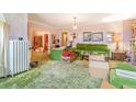 Retro living room featuring shag carpet, green furniture, and plenty of natural light at 2421 N York St, Denver, CO 80205