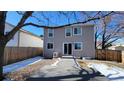 View of the backyard with a gray deck, perfect for outdoor entertaining at 8094 Kline Ct, Arvada, CO 80005