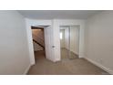 Cozy bedroom with mirrored closet doors and neutral carpet at 8094 Kline Ct, Arvada, CO 80005