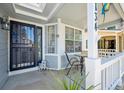 Welcoming front porch featuring a seating area, decorative features, and manicured landscaping at 5134 S Ouray Ct, Centennial, CO 80015