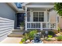 Inviting front porch with decorative accents, a charming fountain, and well maintained plants at 5134 S Ouray Ct, Centennial, CO 80015