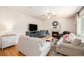 Cozy living room features a fireplace, ceiling fan, and ample seating at 3406 Quicksilver Rd, Frederick, CO 80516