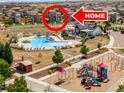 Aerial view showcases community pool and playground at 10062 Southlawn Cir, Commerce City, CO 80022