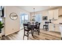 Cozy dining area with modern light fixture and sliding door access to the outdoors at 5134 Queen Ct, Arvada, CO 80002