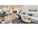 Open-concept living space featuring modern furnishings and hardwood flooring at 5134 Queen Ct, Arvada, CO 80002