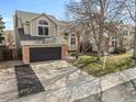 Attractive two-story house boasting a brick-accented facade, a well-kept lawn, and a convenient two-car garage at 96 S Lindsey St, Castle Rock, CO 80104