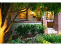 Inviting front entrance showcasing a well-lit porch, brick accents, and lush landscaping at 1121 S Williams St, Denver, CO 80210
