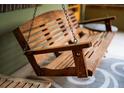 Close-up of a classic wooden porch swing, perfect for relaxing and enjoying the outdoors at 1121 S Williams St, Denver, CO 80210