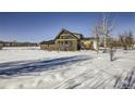 Modern home with a spacious yard in a snowy landscape at 4022 Arleigh Dr, Berthoud, CO 80513