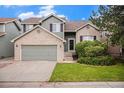 Charming two-story home featuring a brick and siding exterior, a two-car garage, and a well-maintained front yard at 359 Wessex Cir, Highlands Ranch, CO 80126