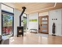 Light-filled entryway featuring hardwood floors, modern gas fireplace, and a contemporary door at 2725 6Th St, Boulder, CO 80304