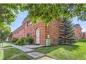 Charming brick home with well-manicured lawn and mature landscaping at 3659 W Union Ave, Denver, CO 80236