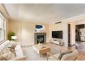 Cozy living room features fireplace, neutral decor, and an open floor plan at 3659 W Union Ave, Denver, CO 80236