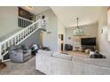 Spacious living room featuring vaulted ceilings, abundant natural light, and comfortable seating at 12013 W 56Th Cir, Arvada, CO 80002