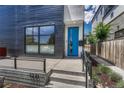 Contemporary home featuring a bright blue front door, modern design, and well-maintained walkway at 1231 Newton St, Denver, CO 80204