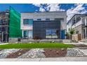 Contemporary home with well-maintained lawn, modern architecture, and stylish landscaping at 1231 Newton St, Denver, CO 80204