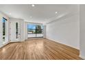 Bright living room featuring hardwood floors, large windows, and neutral paint, creating a warm ambiance at 1231 Newton St, Denver, CO 80204