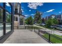 Modern patio with sleek railings and view of street lined with other modern homes at 1231 Newton St, Denver, CO 80204