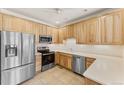 Bright kitchen with light wood cabinets and stainless steel appliances at 22263 E Euclid Dr, Aurora, CO 80016