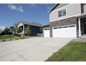 View of a home with a large driveway and a welcoming front porch at 4955 Trails Edge Ln, Castle Rock, CO 80104