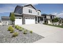Charming two-story home featuring stone accents, a large driveway, and beautifully landscaped yard at 4955 Trails Edge Ln, Castle Rock, CO 80104
