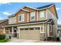 Lovely two-story home with a stone-accented facade and well-kept lawn at 21271 E Smoky Hill Rd, Centennial, CO 80015