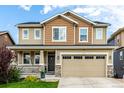Attractive two-story home with a covered porch and two-car garage at 21271 E Smoky Hill Rd, Centennial, CO 80015