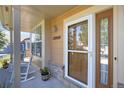 Inviting front porch with rocking chairs and beautiful landscaping leads to the front door at 12000 Pine Top St, Parker, CO 80138