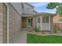 Charming entrance to the home with a well-maintained lawn and garden at 10723 W 54Th Pl, Arvada, CO 80002