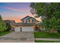 Charming two-story home with a three-car garage and well-manicured lawn at 10723 W 54Th Pl, Arvada, CO 80002