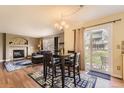 Cozy dining area with backyard access, complemented by fireplace and hardwood floors leading into the adjacent living room at 20910 Omaha Ave, Parker, CO 80138