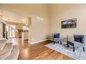 Inviting living room with hardwood floors, neutral paint, and decor, plus easy access to the kitchen and natural light at 20910 Omaha Ave, Parker, CO 80138