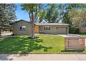 Well-manicured lawn and mature tree accent the facade of this charming single-Gathering home at 7092 E Mexico Ave, Denver, CO 80224