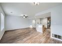 Bright and spacious living room featuring wood flooring, ceiling fan, and stainless steel appliances at 19046 E 57Th Pl # B, Denver, CO 80249