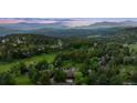 Expansive mountain view featuring a residential community nestled amongst green forests and winding roads at 24036 Currant Dr, Golden, CO 80401