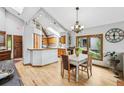 Open dining area with hardwood floors, natural light and vaulted ceilings adjacent to kitchen at 24036 Currant Dr, Golden, CO 80401