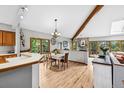 Inviting dining area with hardwood floors, exposed beam, natural light, and easy kitchen access at 24036 Currant Dr, Golden, CO 80401