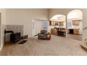 Open-concept living area with fireplace, vaulted ceilings and wood burning stove at 250 Upper Forest Rd, Idaho Springs, CO 80452