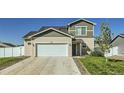 Inviting two-story home featuring a two-car garage, solar panels, and well-manicured lawn at 529 Beckwourth, Fort Lupton, CO 80621