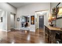 Inviting foyer showcasing hardwood floors, a view of the office, and stylish decor at 23600 E Swallow Cir, Aurora, CO 80016