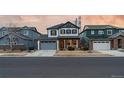 Charming two-story home featuring a manicured lawn, stone accents, and an attached two-car garage at 14845 Haley Ave, Parker, CO 80134