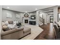 Comfortable living room featuring a fireplace, a plush sofa, and neutral decor at 14845 Haley Ave, Parker, CO 80134