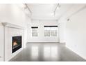 Bright, open living space with modern floors, fireplace, and large windows at 1780 N Washington St # 305, Denver, CO 80203