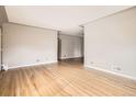 Bright, empty living room featuring hardwood floors and neutral walls awaiting personal touches at 2710 Zenobia St, Denver, CO 80212