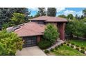 Charming home featuring a tile roof, solar panels, landscaped yard, and a modern garage at 463 Locust St, Denver, CO 80220